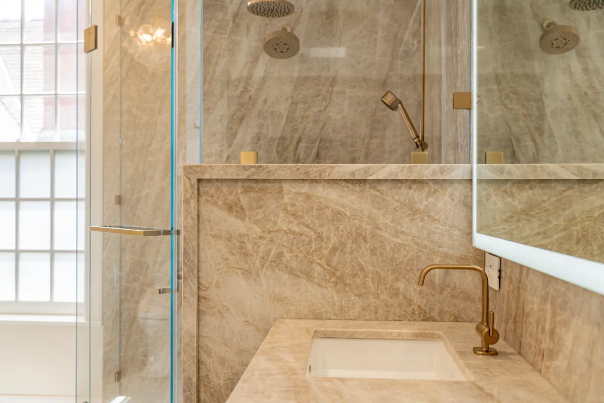 Stone-clad shower and vanity selections in a San Diego bathroom remodel