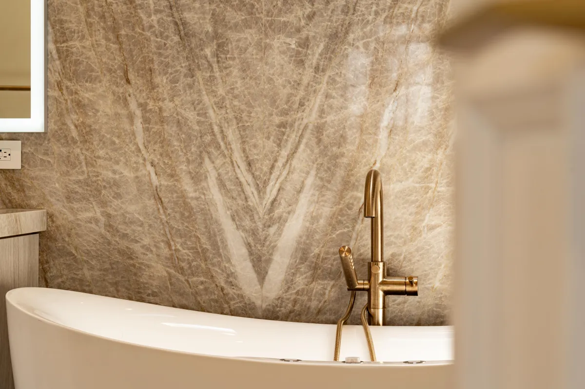 Freestanding soaking tub with brass fixtures in a finished KSH bathroom